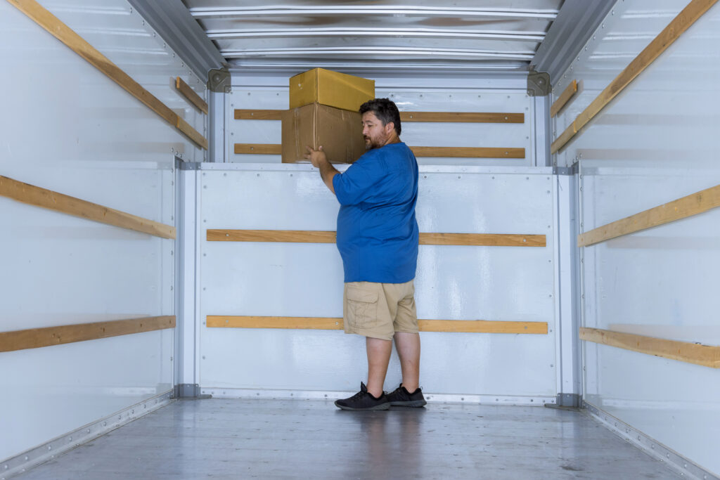 Delivery boxes man holding in boxes with moving car